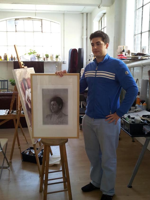 Cristian De La Peña beside an easel in his studio